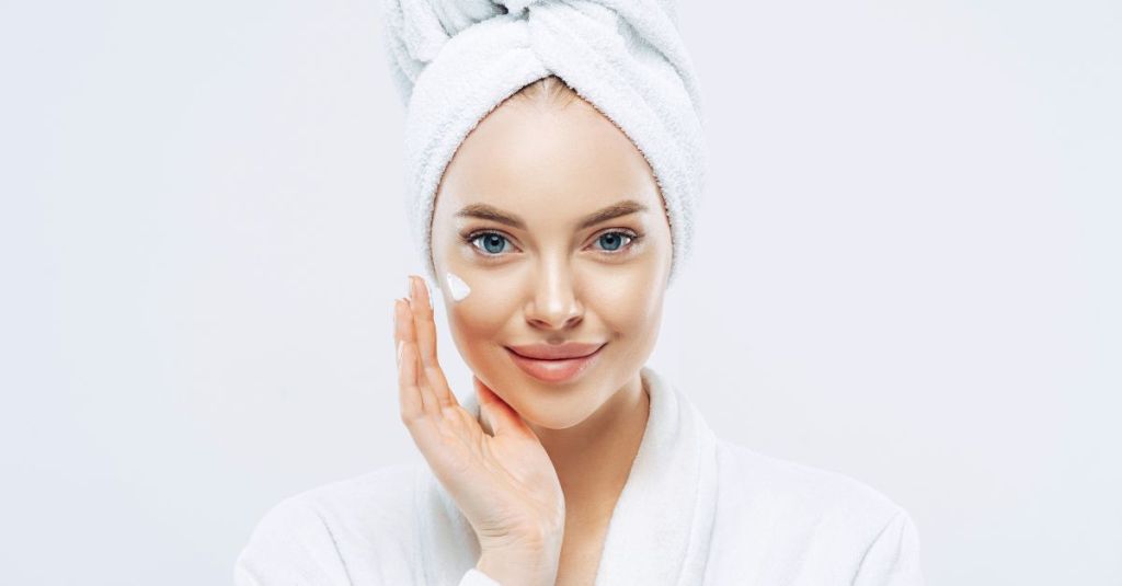 Woman smiling doing anti-aging skincare for oily skin