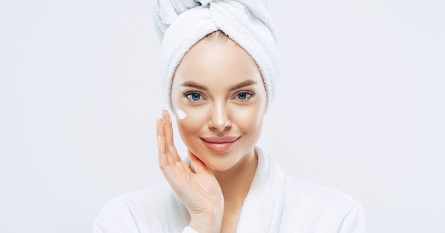 Woman smiling doing anti-aging skincare for oily skin